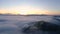Amazing clouds of dense fog move flowing over mountain sunrise or sunset sky fog scenic aerial view. Drone flies over sky