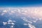 Amazing clouds and the sky as seen through the window of an aircraft. Clouds, sun, sky as seen through window of an aircraft.