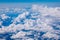 Amazing clouds and the sky as seen through the window of an aircraft. Clouds, sun, sky as seen through window of an aircraft.