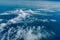 Amazing cloudscape view from window of airplane, aerial view of fluffy clouds