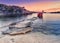 amazing coastal landscape at sunset. Rock beach and single little boat.