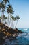 Amazing Coconut palm hill in Mirissa bay in Sri lanka. Palms silhouette over blue ocean beach