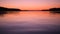 Amazing colorful pink sunset sky and lake water surface. Calm Nature 4K Background Footage.