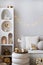 Amazing composition on white design shelf with christmas decoration, lights, gifts, lanterns ,deer, candles, stars, white corduroy