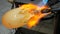 Amazing creation of a work of art from molten glass. The flame warms the ductile material.