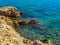 Amazing crystal clear blue water and sharp rock edges on the shore