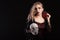 Amazing dead girl dressed up like vampire holding a skull for halloween carnival