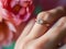 a amazing delicate flowers a woman wears a ring on her finger.Generative AI