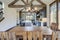 Amazing dining room near modern and rustic luxury kitchen with vaulted ceiling and wooden beams, long island with white quarts