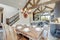 Amazing dining room near modern and rustic luxury kitchen with vaulted ceiling and wooden beams, long island with white quarts