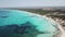 Amazing drone aerial landscape of the charming beach Es Trencs and the boats with a turquoise sea.