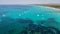 Amazing drone aerial landscape of the charming beach Es Trencs and the boats with a turquoise sea
