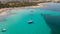 Amazing drone aerial landscape of the charming beach Es Trencs and the boats with a turquoise sea