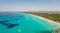 Amazing drone aerial landscape of the charming beach Es Trencs and the boats with a turquoise sea