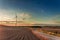 Amazing dusk at field with wind turbine in autumn