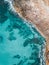 Amazing eagle-eye vertical shot of a sea colliding the shore