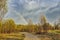 Amazing early spring landscape with rainbow over country road