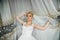 Amazing elegance cute stilysh blonde bride is posing on the bac