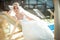 Amazing elegance cute stilysh blonde bride is posing on the bac