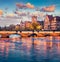 Amazing evening view of Munsterbrucke Bridge and Zurich town hall. Fantastic autumn cityscape of Zurich, Switzerland, Europe. Suns