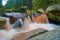 Amazing falling water stream between huge stones and rocks in river Vydra, Czech republic