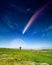 Amazing fantastic image: giant colorful comet and rising full moon in deep blue sky over green meadow