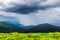 Amazing flowing rainy clouds in evening mountains