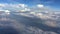 Amazing footage of aerial view above the clouds. View from the airplane window to the blue sky and white clouds