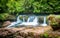 Amazing forest waterfall flowing into the cold mountain river. Martvili canyon. Nature fall