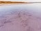 Amazing forms of land surface made of water and salt, nature abstract background, aerial view. Pink extremely salty