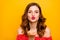 Amazing foxy lady sending boyfriend air kiss wear red dress isolated yellow background