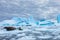 Amazing frozen landscape from Antarctica with Crabeater seals resting on icebergs and staring at camera, blue ice and stunning
