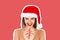 Amazing funky teen woman posing in christmas hat. emotional woman in red santa claus hat Magazine collage style with trendy color