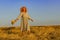 Amazing girl in a hat at sunset in the steppe on the sea