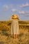 Amazing girl in a hat at sunset in the steppe on the sea