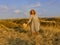 Amazing girl in a hat at sunset in the steppe on the sea