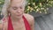 Amazing girl in the red bathing suit sitting in the lotus position on the wooden floor