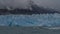 Amazing glacier Perito Moreno on the background of mountains and cloudy sky.
