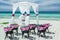 Amazing gorgeous inviting view of wedding decorated gazebo with old vintage black metal chairs on the beach