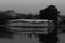 Amazing grayscale shot of a city with coastal building reflections on calm lake water