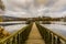 Amazing image of a wooden path leading to a gazebo in the middle of the Doyards Lake