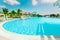amazing inviting view of two level swimming pool, tranquil turquoise clear water with people in backgroun on sunny gorgeous day