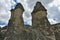 The amazing landscape of Cappadocia. Against the background of the sky with picturesque clouds towering cylindrical cliffs of tufa