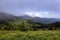 Amazing landscape with high mountains, fog and sky. The early morning mist. Majestic spring day. Dense fog with beautiful light.