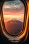 Amazing landscape of mountain through window of flying airplane