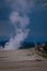 Amazing landscape of Unidentified people walking in a wooden boardwalk close to small geysers, hot springs, and vents