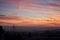 An amazing landscape view at sunrise with red orange blue vivid sky. Natural background with suburbs of the city and beautiful