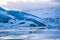 Amazing landscapes and huge glaciers in the Jokulsarlon Glacier Lagoon glacial river lagoon, with a wild seal swimming in the la