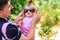 Amazing little girl is playing with sunglasses with her father