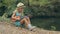 Amazing little girl with straw hat sitting by the